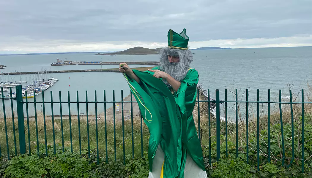 Mark dressed as a Saint Patrick overlooking howth pier.